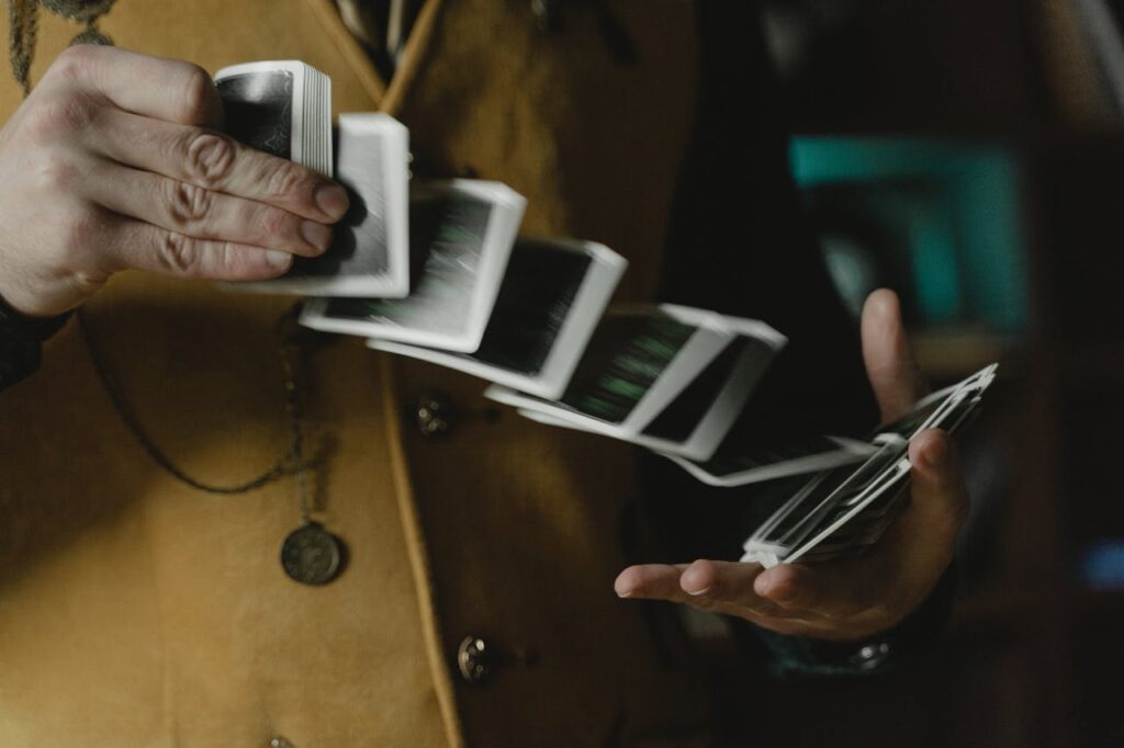 Close-up of hands performing a card trick, showcasing dexterity and elegance in motion.